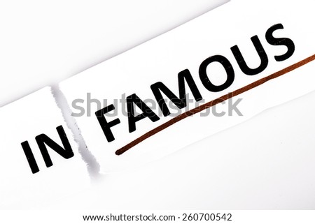 The word infamous changed to famous on torn paper and white background