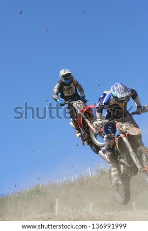 Two motocross bikes in mid air