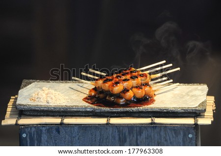 Chopsticks with something sweet and hot ready to be eaten in the area of Gion, Kyoto, Kyoto Prefecture, Japan
