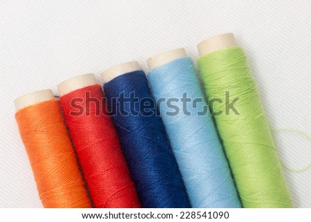 Spools of multi-colored threads