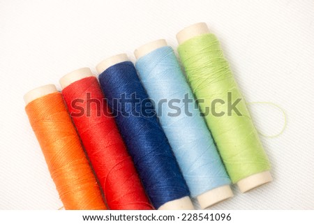 Spools of multi-colored threads