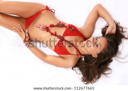 Sexy girl lie-down dressed in red swimming suit