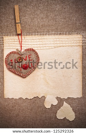 Art greeting card on vintage background with heart, old paper, fabric and words I Love You