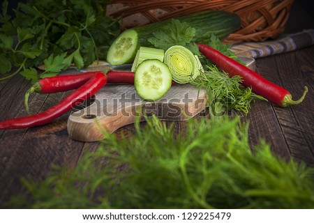 Art vintage composition with early vegetables on wooden board
