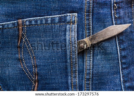 Old knife in the back pocket of jeans