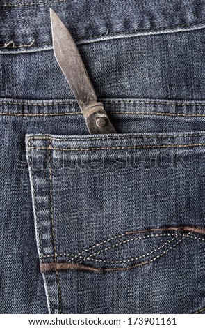 Old knife in the back pocket of jeans