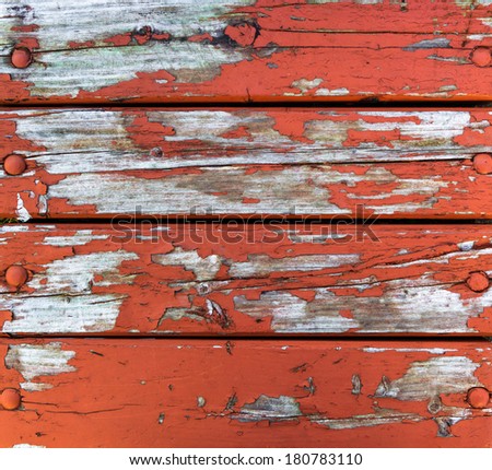 The wood paneling of the old cracked paint