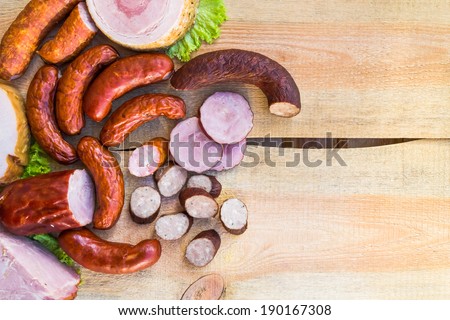 Smoked meat on a wooden table with empty space for text