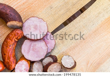 Smoked meat on a wooden table with empty space for text