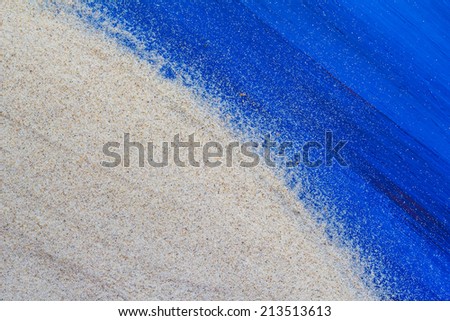 Marine background with sand spilled on a wooden table