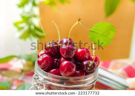 Fresh fruit cherries in a jar for products processed