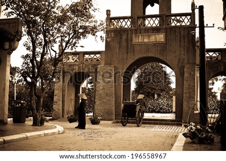 Old gate to the village in china with people / Gate to the village