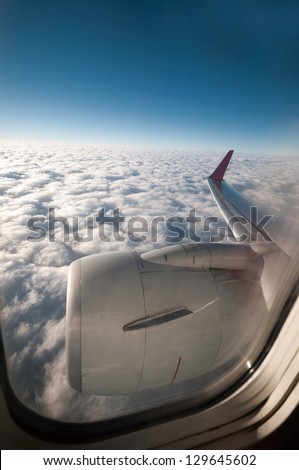 View from a jet plane window high on the blue skies