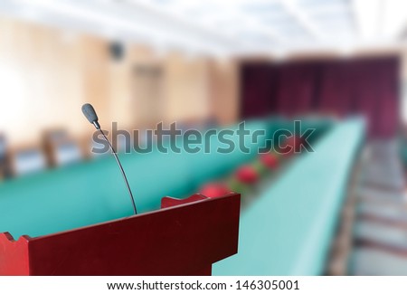 before a conference, the microphones in front of empty chairs.