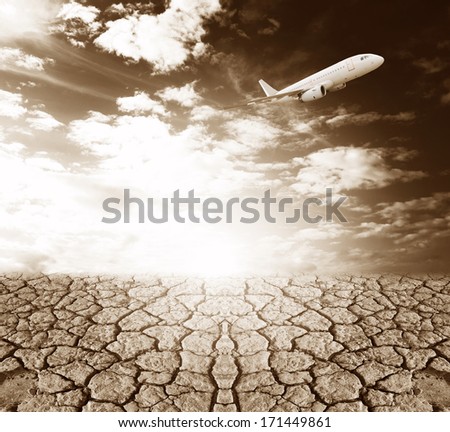 land with dry cracked ground and blue sky