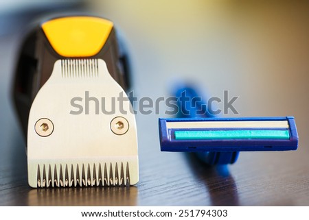 Macro shot of beard trimmer against razor