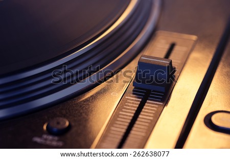 Spinning vinyl disc on retro turntable with pitch control in focus. Vintage effect.