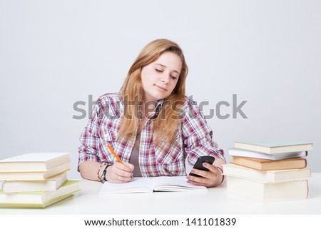A beautiful college student checks social media during a class break.