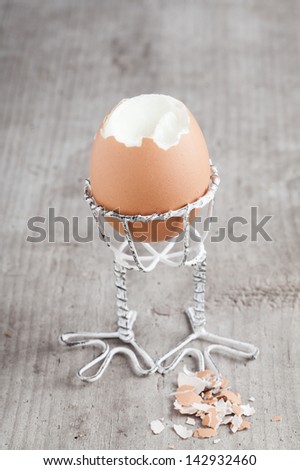Boiled egg in an eggcup on wooden background v