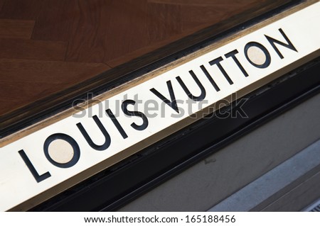 Florence, ITALY - December 8, 2011: Louis Vuitton Logo mounted on the marble wall of Louis Vuitton Store at Via de\' Tornabuoni, the heart of Florence high-class shopping district