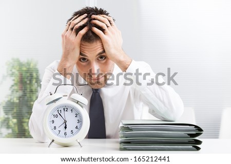 Stressed business man under time pressure cries in office