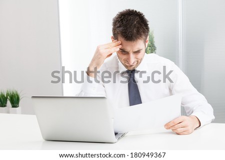Businessman confused and Scratching Head, with Laptop