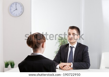 Business people having job interview with young woman