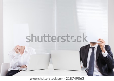 People working at the office with paper on the face