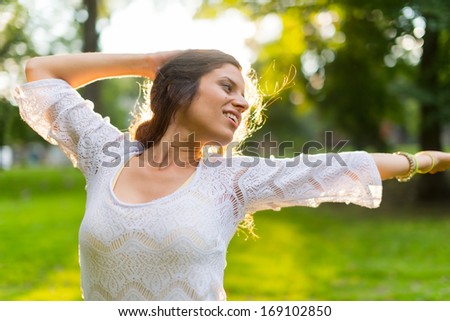 Serene young woman expressing freedom in nature