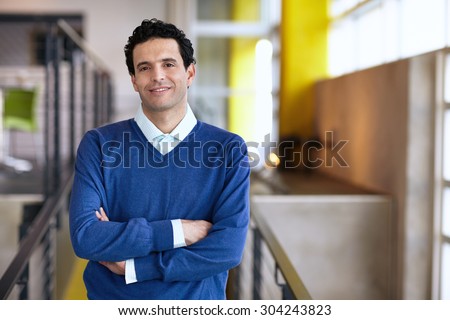 Portrait of a confident businessman at work in his glass office