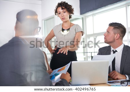 team of successful business people having a meeting in executive sunlit office