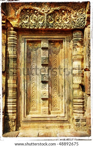 stone door with carving at ancient cambodian temple