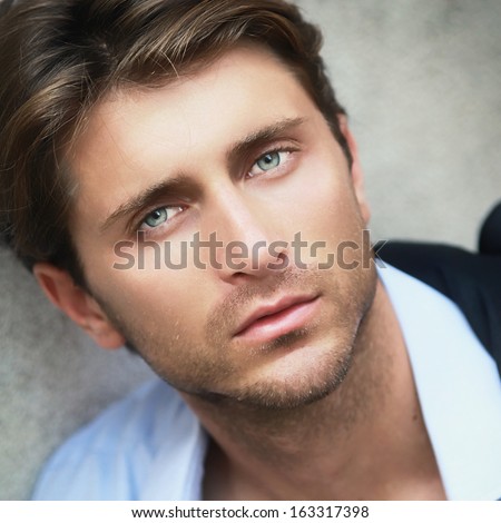 portrait of young man with impressive green eyes