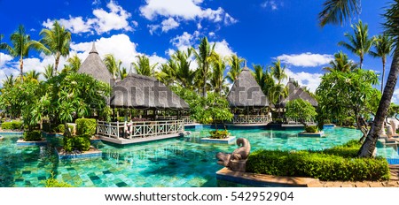 Tropical vacations. Luxury resort with swimming pool and lounge bar in Mauritius island. Flic en Flac beach