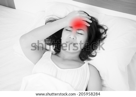 woman lying in bed with headache, migraine, stress, insomnia, hangover with red alert accent