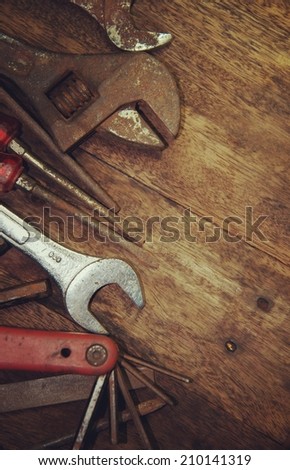 tool renovation on brown wood background with retro filter effect