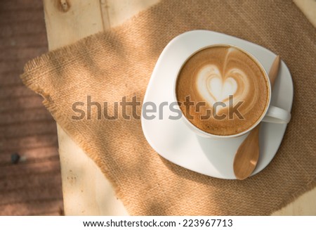 A cup of cafe latte with heart shape