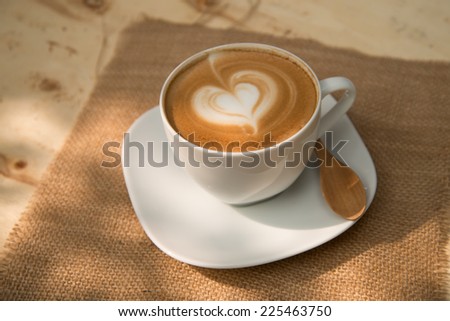 A cup of cafe latte with heart shape