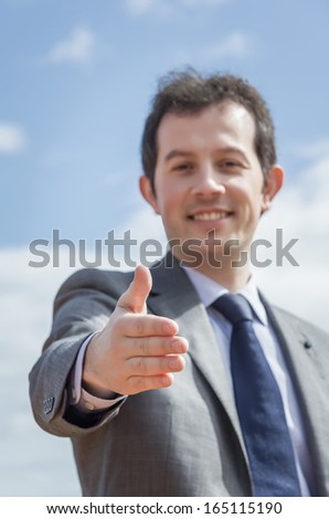 Closeup of business man showing his open hand ready for seal a deal