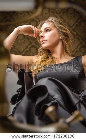Portrait of beautiful fashion girl with black spanish flamenco dress posing in a vintage bathtub