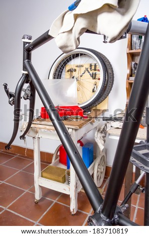 Closeup of custom fixie bike parts in a restoration process inside the workshop