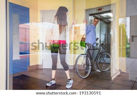Handsome casual business man and beautiful girl with sportswear waving in a office hall entrance behind the glass wall