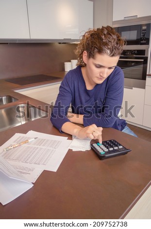 Unemployed and divorced woman with many debts reviewing her monthly bills