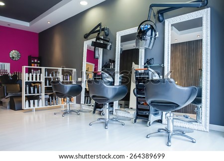 Interior of empty modern hair and beauty salon decorated in gray and fuchsia colors