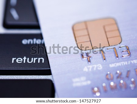 Credit cards on keyboard with microchip, e-commerce concept