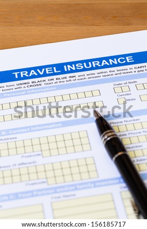 Travel insurance application form with pen concept for travel planning