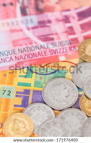 Switzerland money swiss franc banknote and coins close-up (focus on coin)