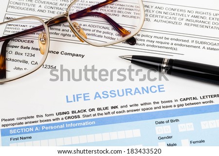 Life assurance application form with pen and glasses concept for life planning