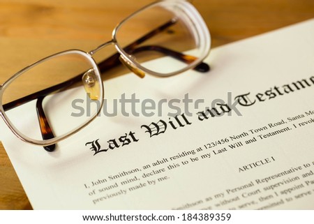 Last will and testament on cream color paper with glasses