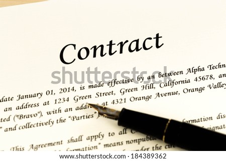 Business contract document on cream color paper with pen